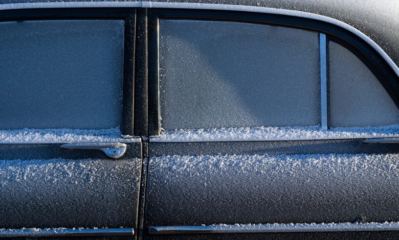Car windows covered with snow